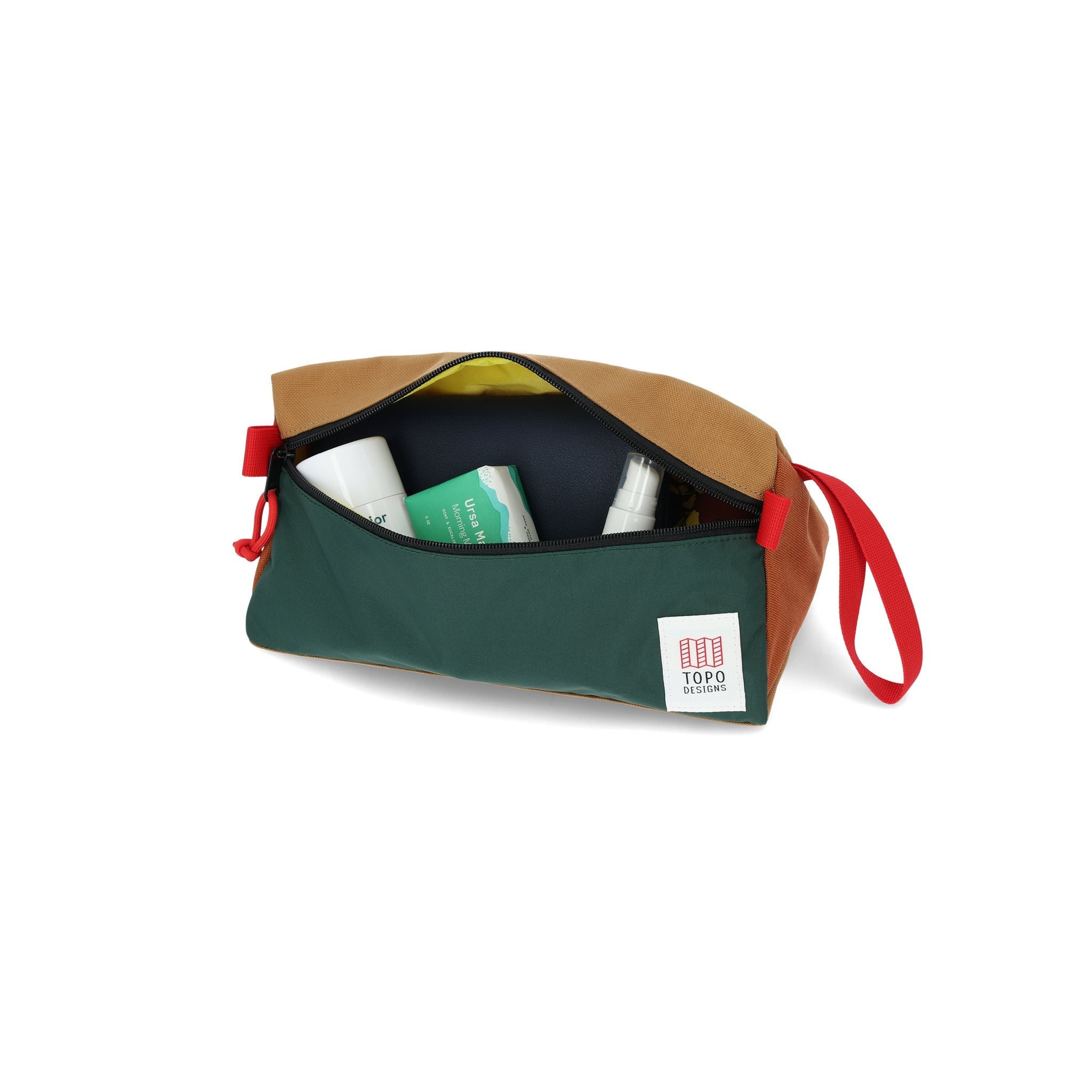 Travel toiletries inside Topo Designs Dopp Kit bag in 100% recycled nylon Forest green & Khaki brown.