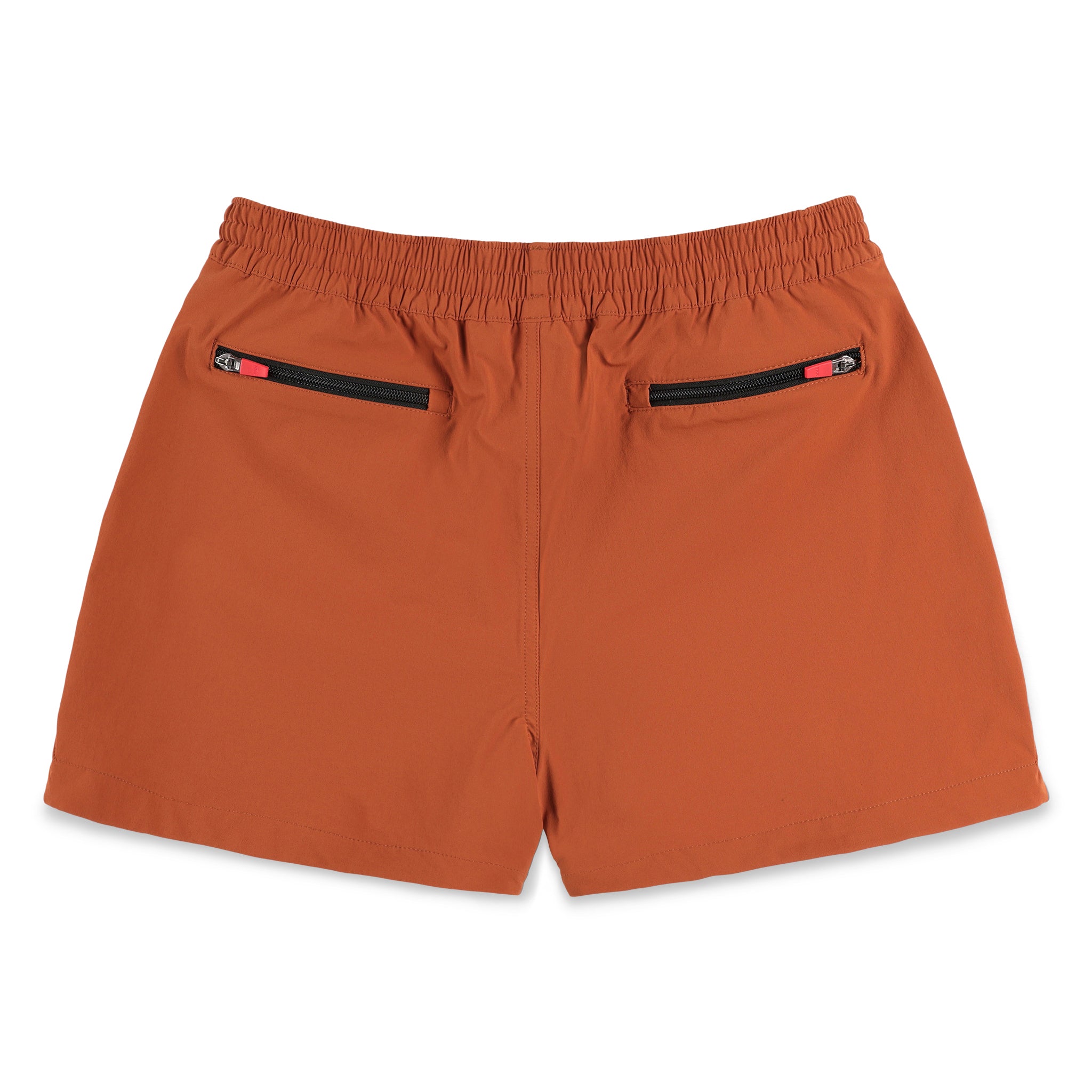 Back zipper pockets on Topo Designs Women's Global lightweight quick dry travel Shorts in "Brick" orange.