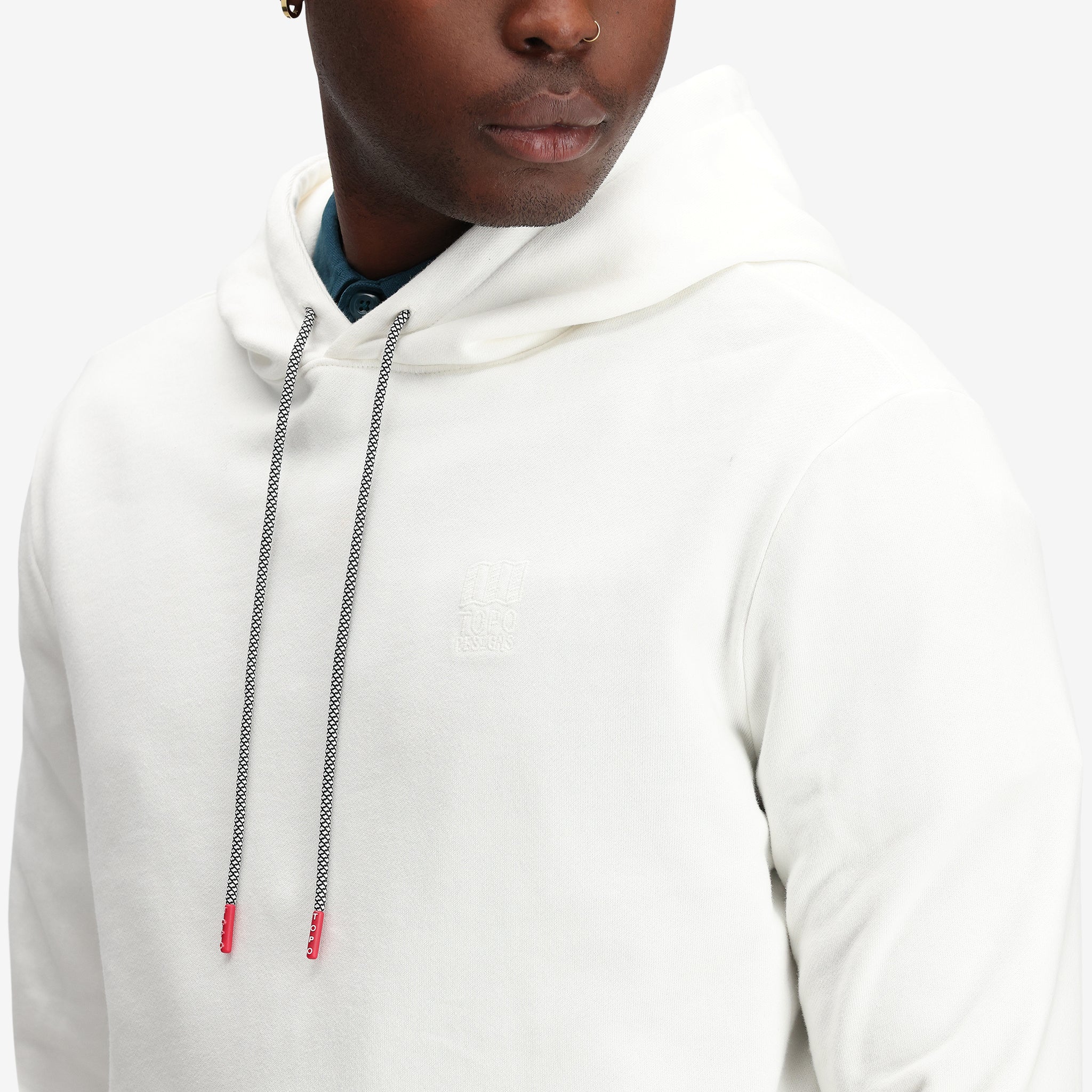 Detail shot of Topo Designs Men's Dirt Hoodie 100% organic cotton French terry sweatshirt in "natural" white.