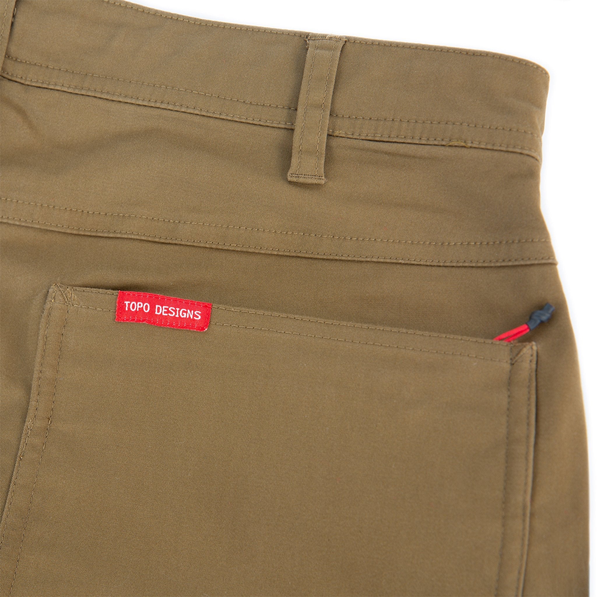 Topo Designs Men's Global Pants lightweight cotton nylon travel pants in Dark Khaki brown showing zipper back pockets.