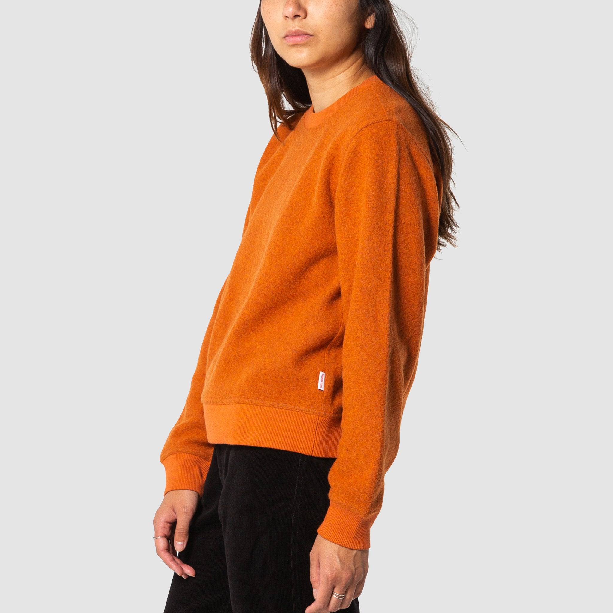 Side model shot of women's global sweater in clay