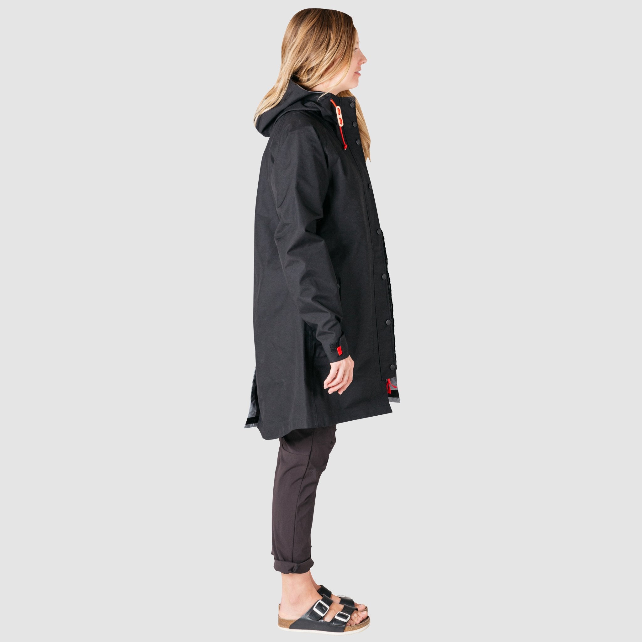 Side full body model shot of women's tech trench 3L in black