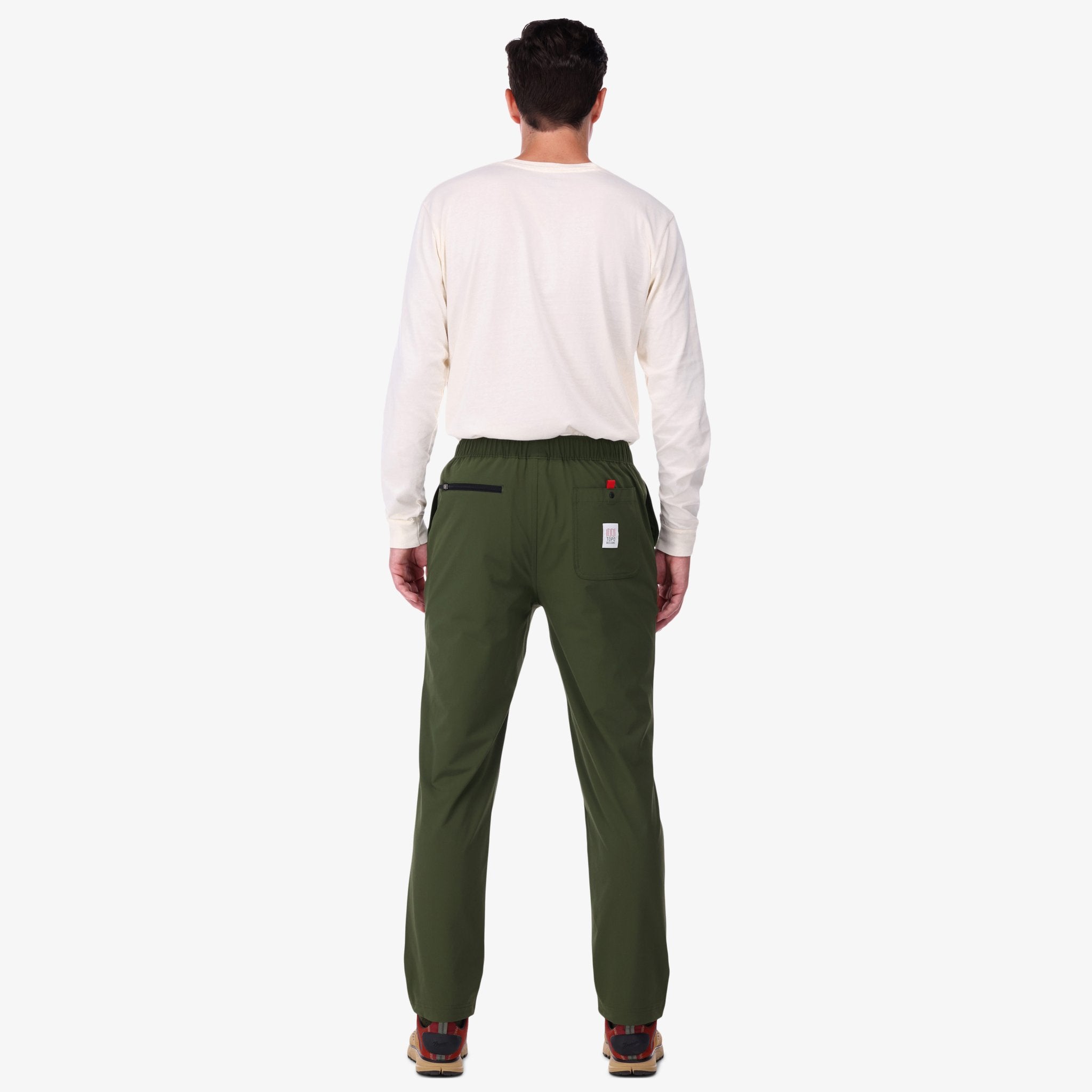 Back shot of Topo Designs Men's Boulder lightweight climbing & hiking pants in "Olive" green on model.