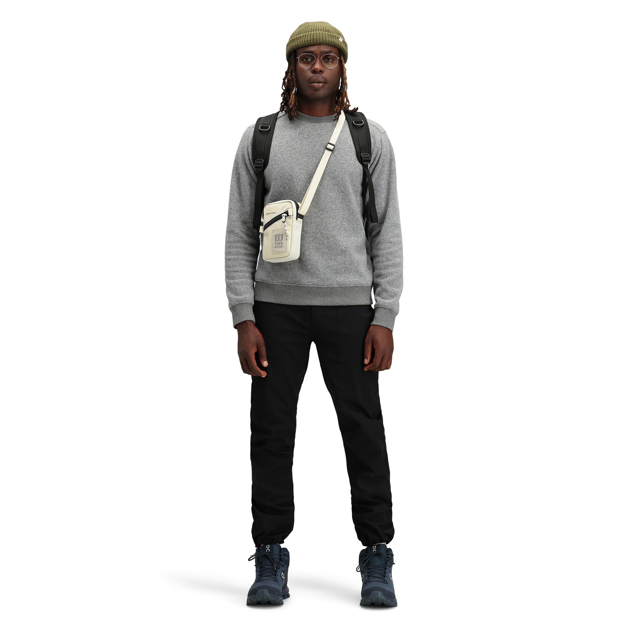 Model wearing Topo Designs Men's Global pullover Sweater recycled washable Italian wool in "Gray"