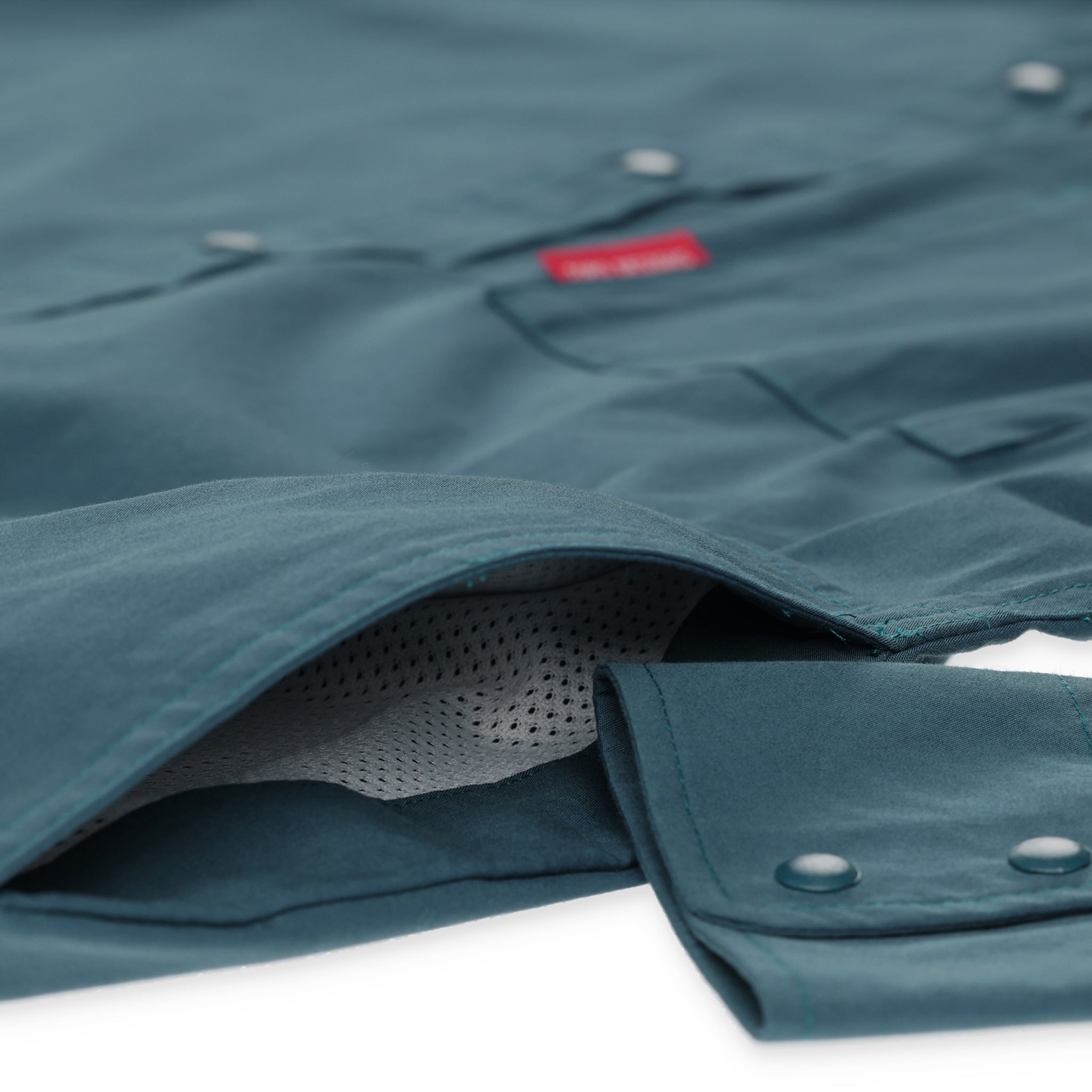 General detail shot of side hand pockets on Topo Designs Men's Global Shirt long sleeve lightweight travel snap shirt in "Pond Blue"