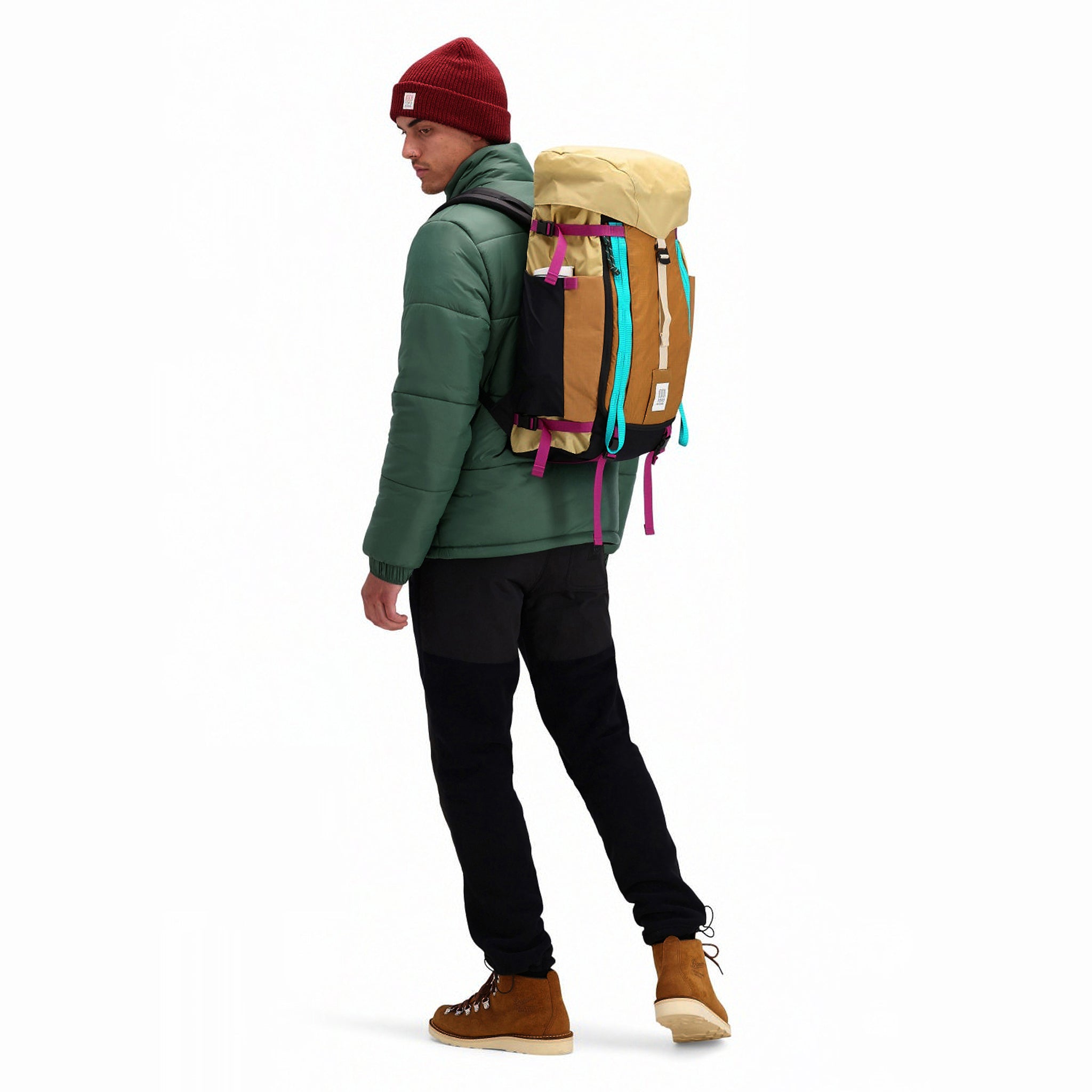 Back model shot of Topo Designs Men's Puffer recycled insulated Jacket in "Forest" green.