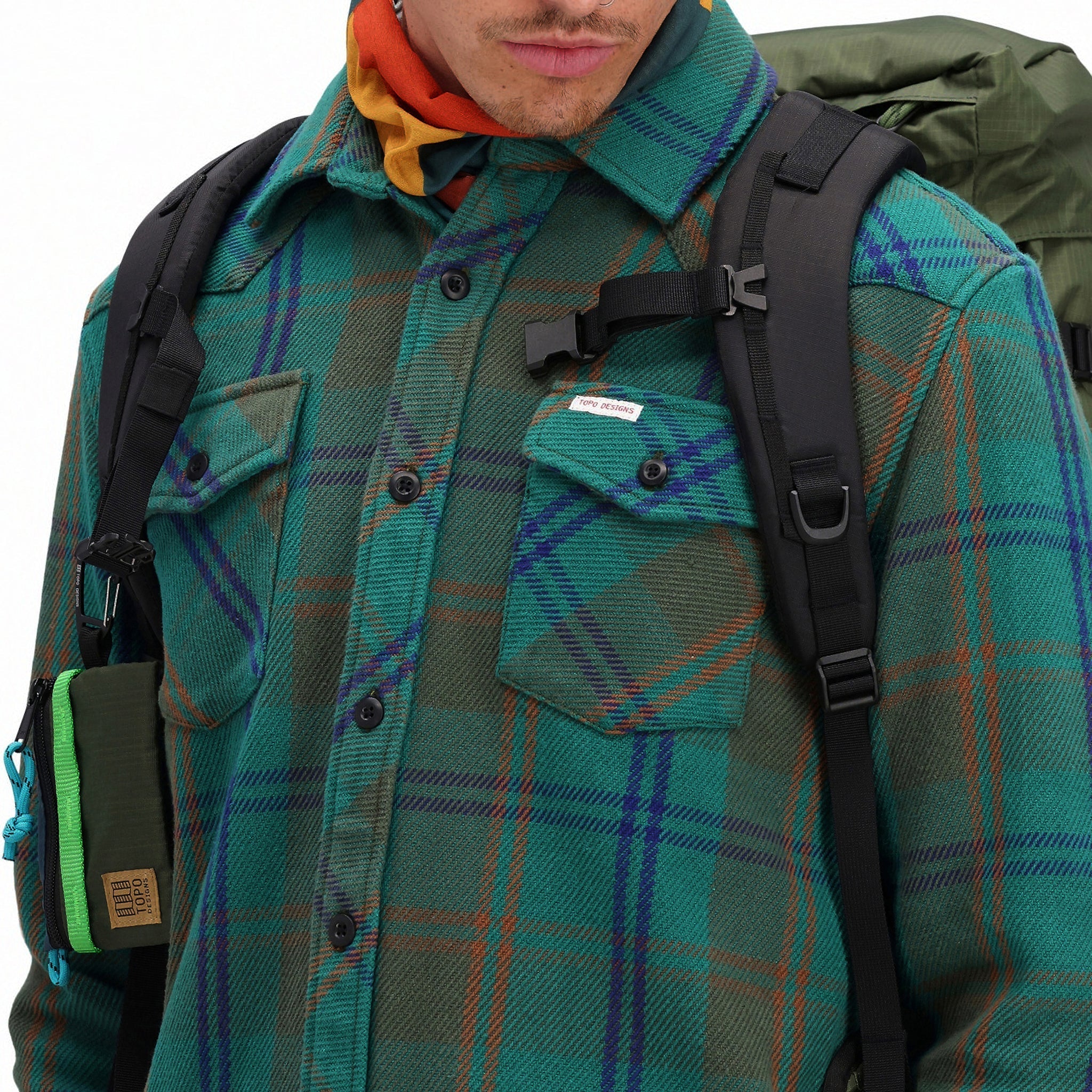 Front detail shot of chest pockets on Topo Designs Men's Mountain Shirt Heavyweight "Green / Earth Plaid" brown blue button-up.
