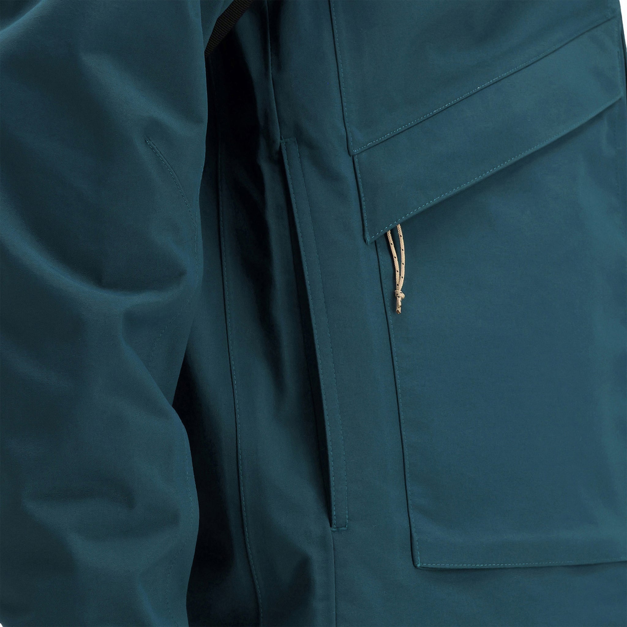 General detail shot of hand pockets on Topo Designs Men's Mountain Parka waterproof shell jacket in "Pond Blue"