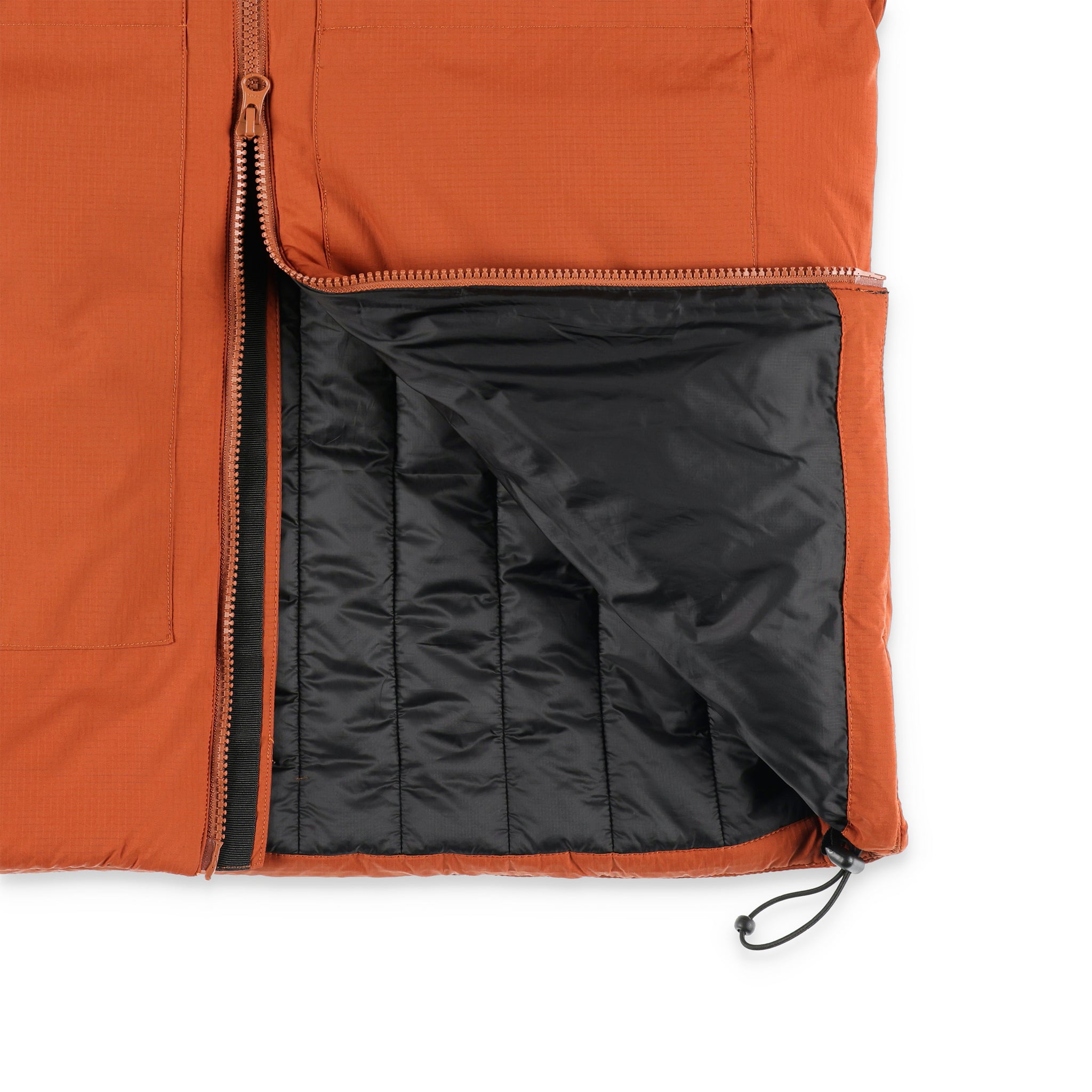 General detail shot of zipper and interior baffles on Topo Designs Mountain Puffer Primaloft insulated Hoodie jacket in "Brick" orange