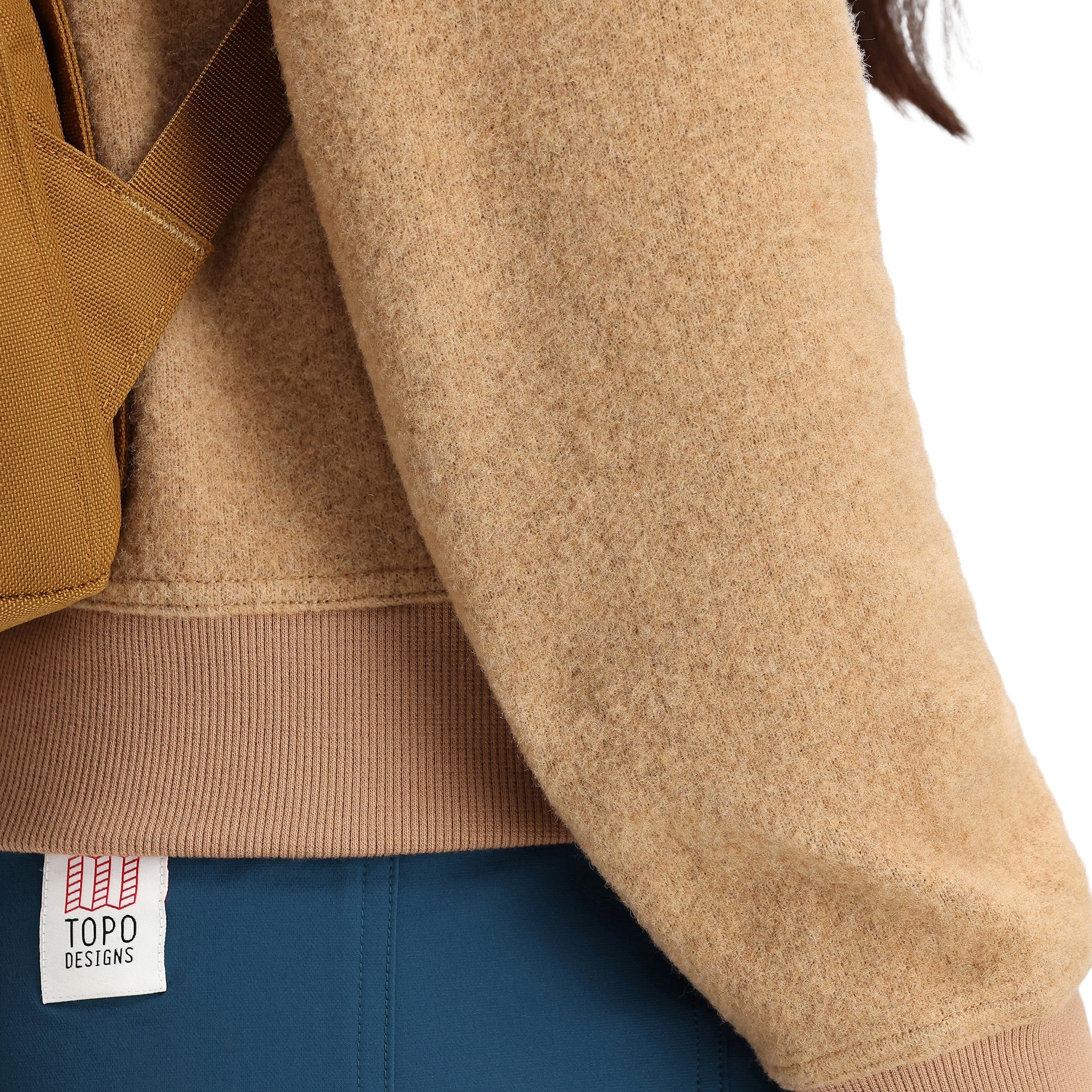 General detail of fabric material texture on Topo Designs Women's Global Sweater recycled Italian wool crewneck pullover in "Camel" brown