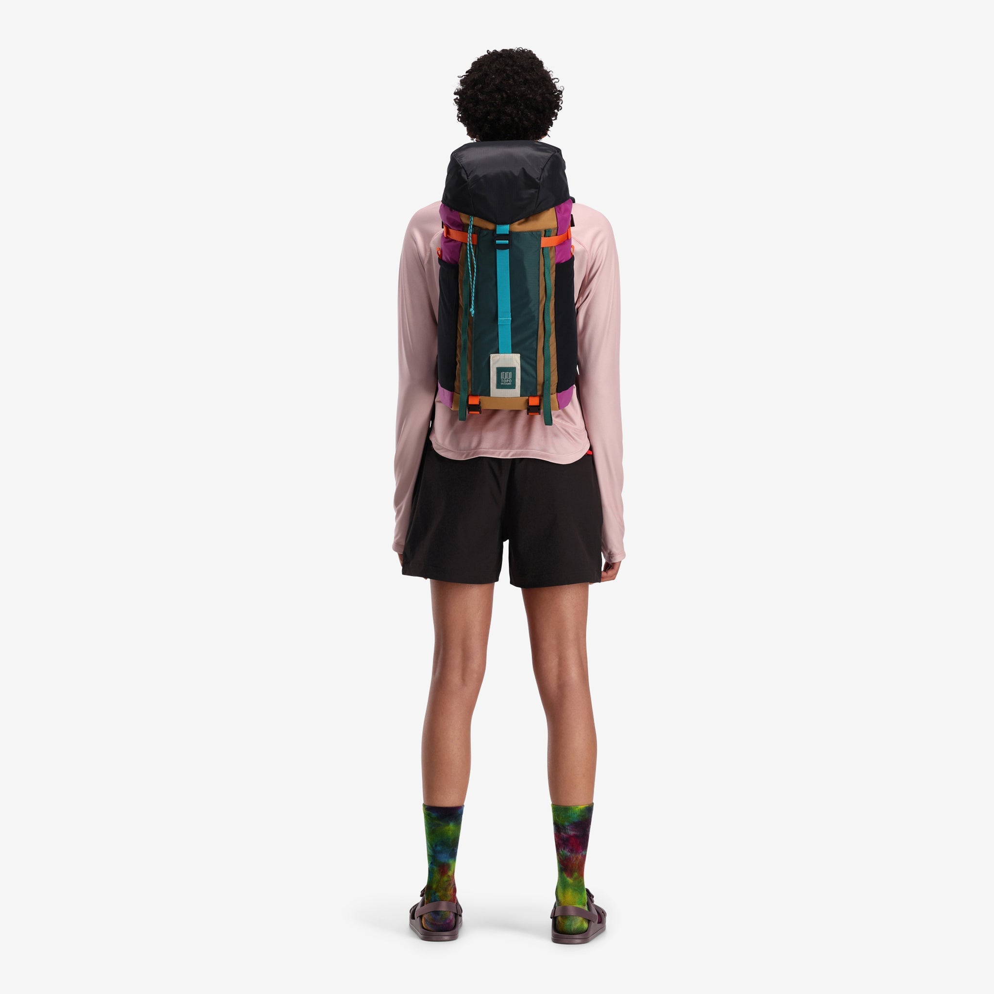 Back model shot of Topo Designs Mountain Pack 16L hiking backpack with internal laptop sleeve in lightweight recycled nylon "Botanic Green / Grape". Show on "Burgundy / Dark Khaki" and "Bone White / Olive".