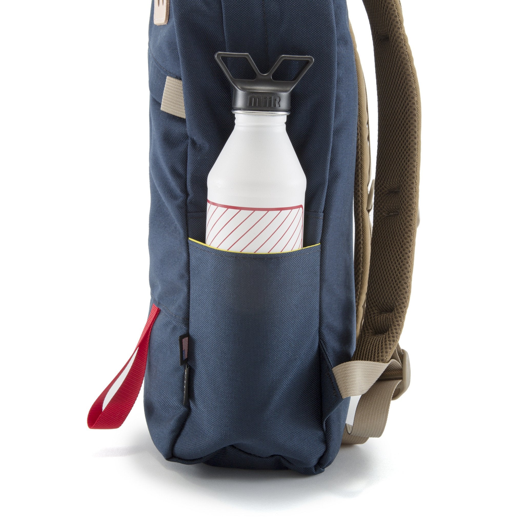 Side water bottle pocket on Topo Designs Daypack in Navy.